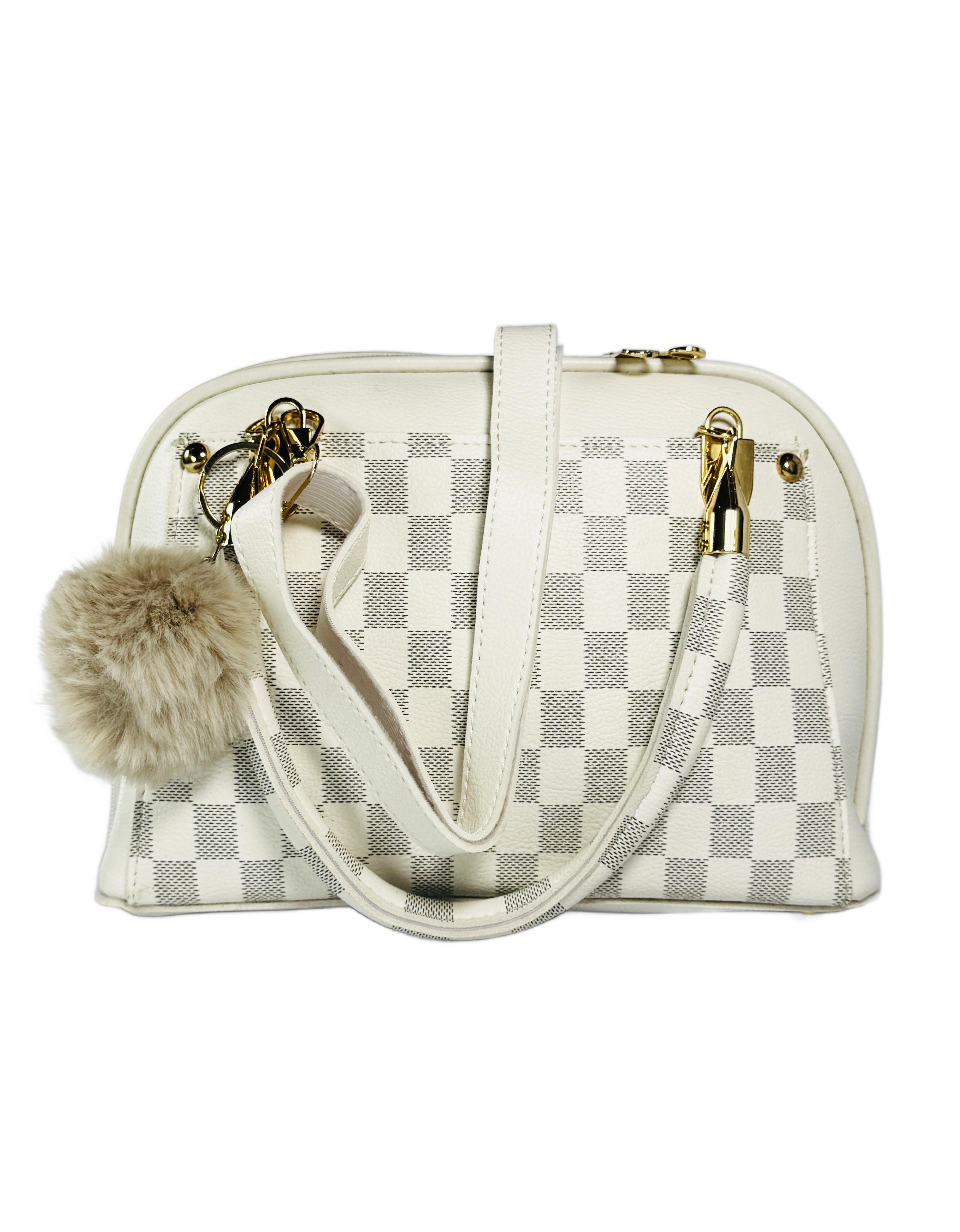 Checkered handbag with pom-pom detail on a white background