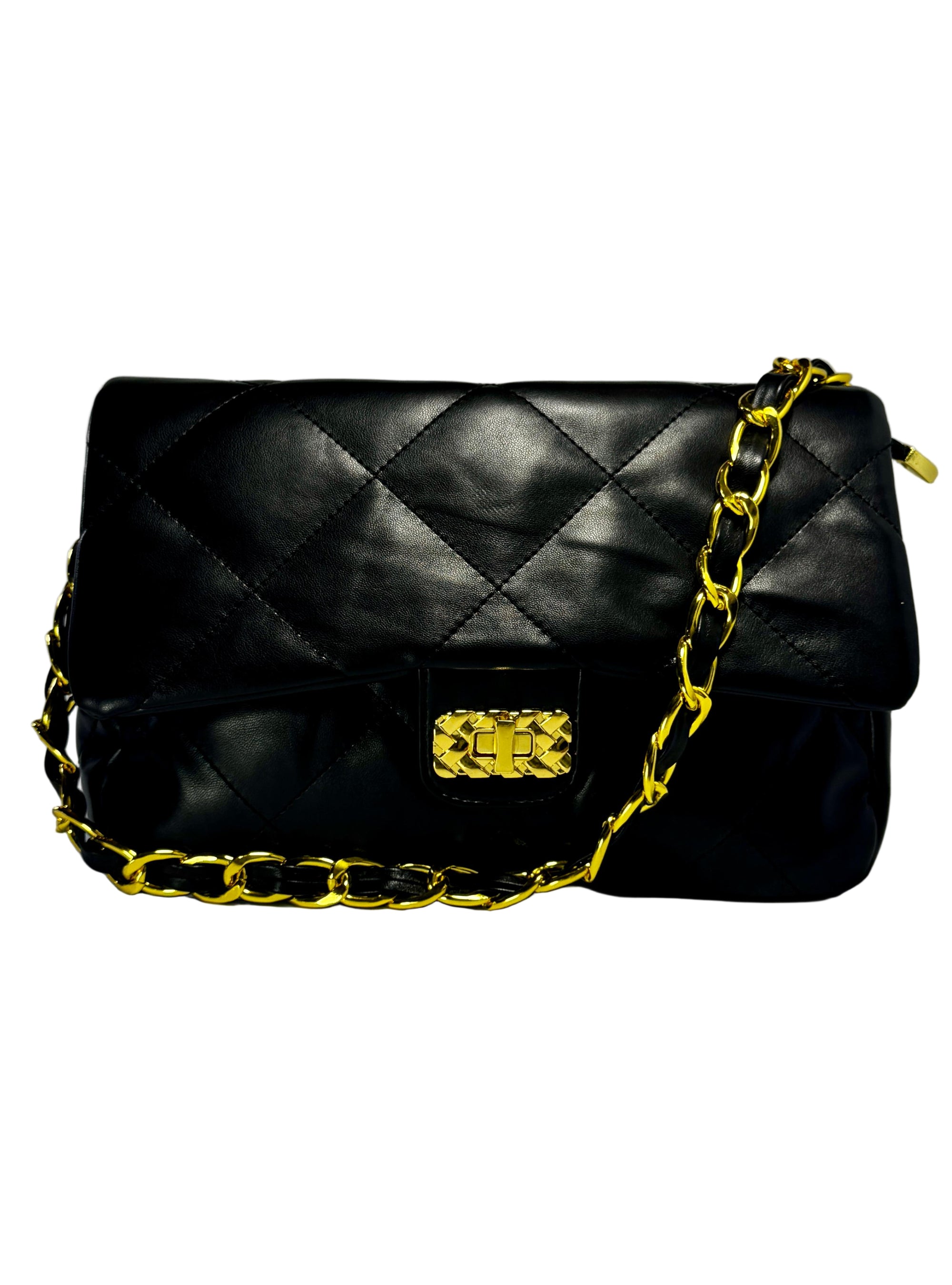 Black quilted handbag with a gold chain strap on a light gray background
