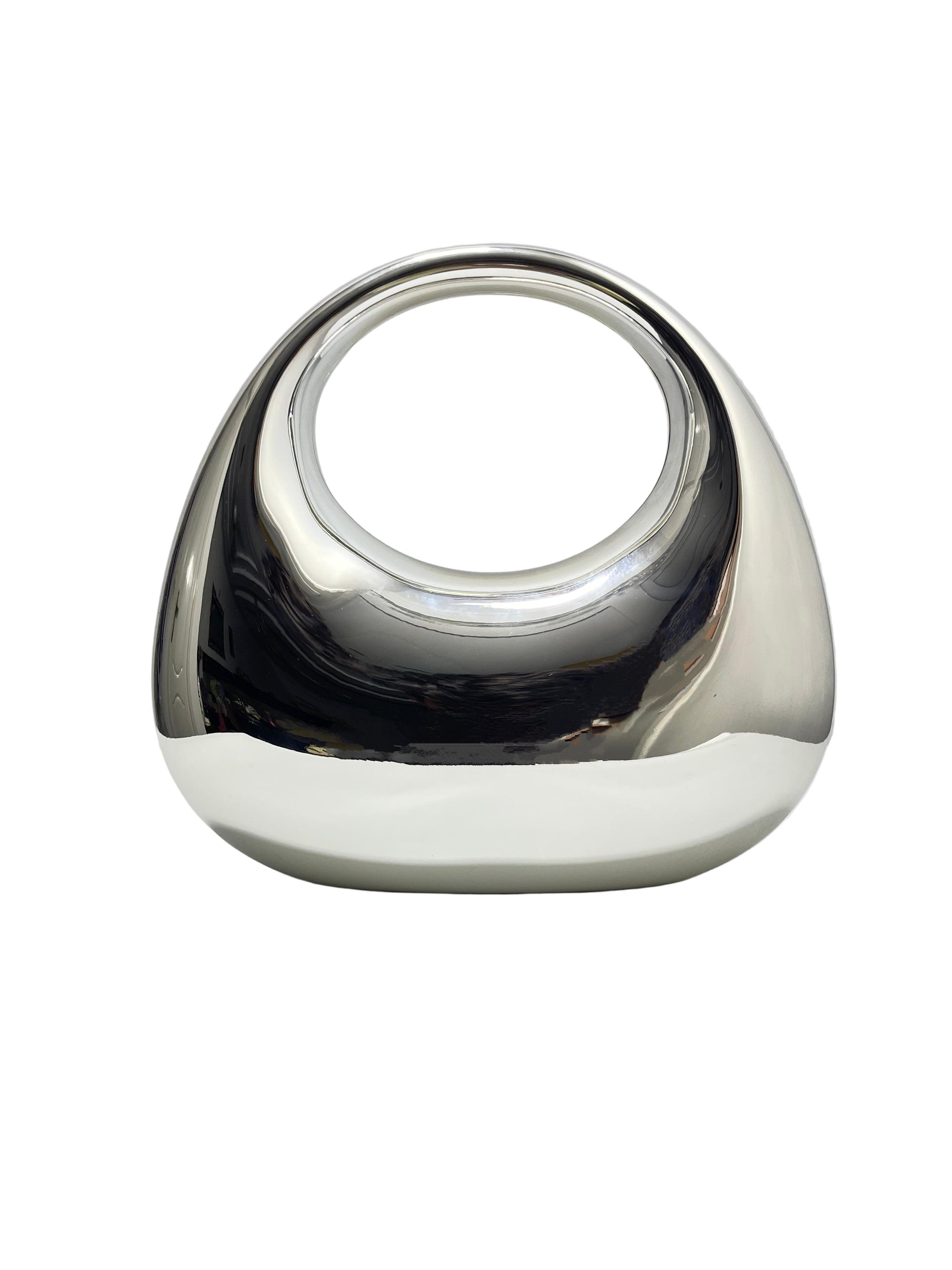 Silver and white decorative object on a light gray background