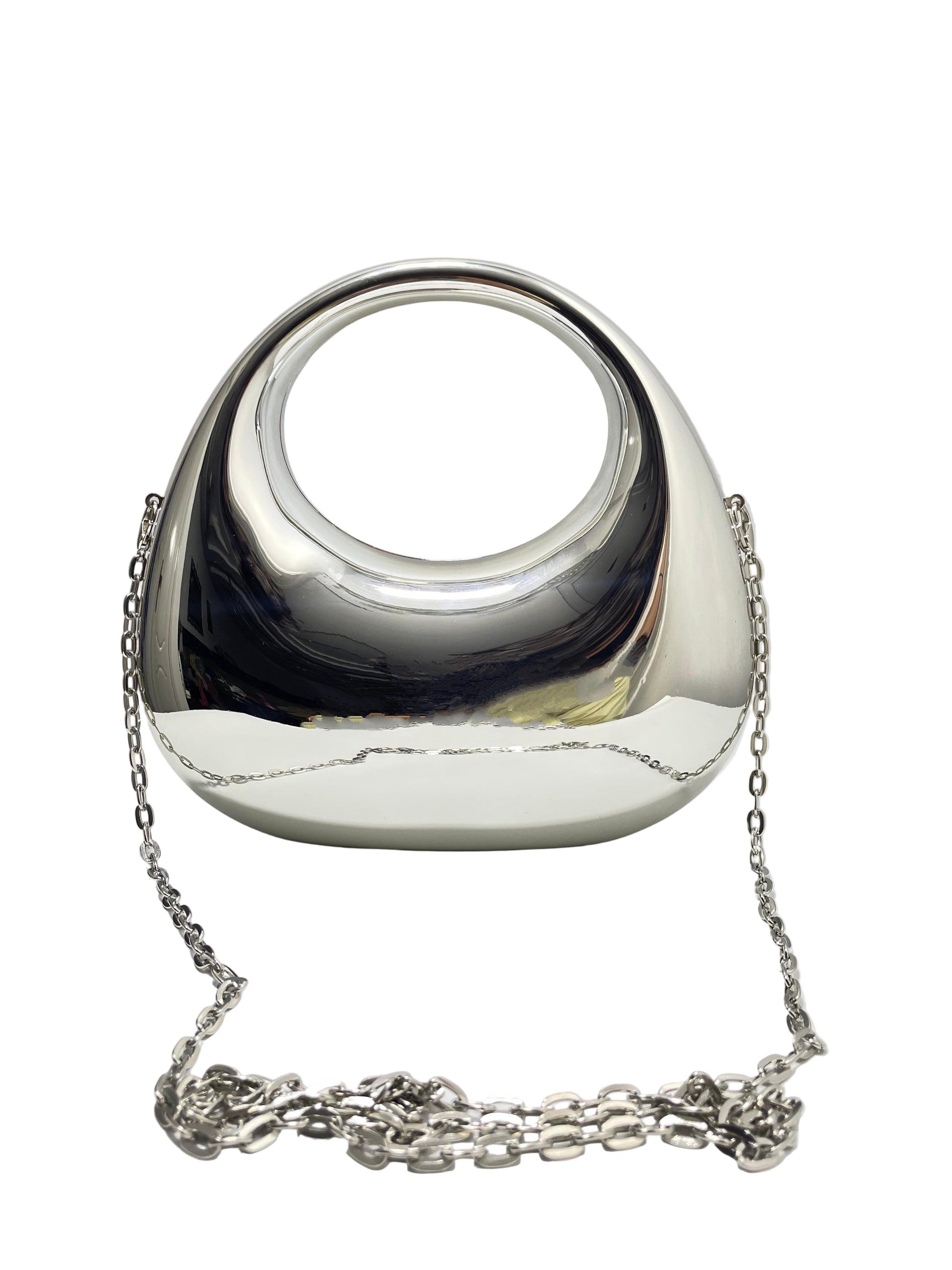 Silver handbag with chain strap on a white surface